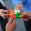 Zarządzanie zasobami ludzkimi Group of business people assembling jigsaw puzzle and represent team support and help concept